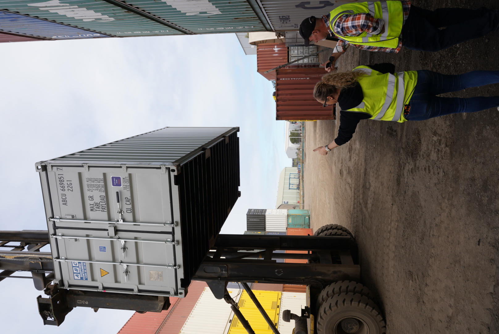 Two people inspecting a container together